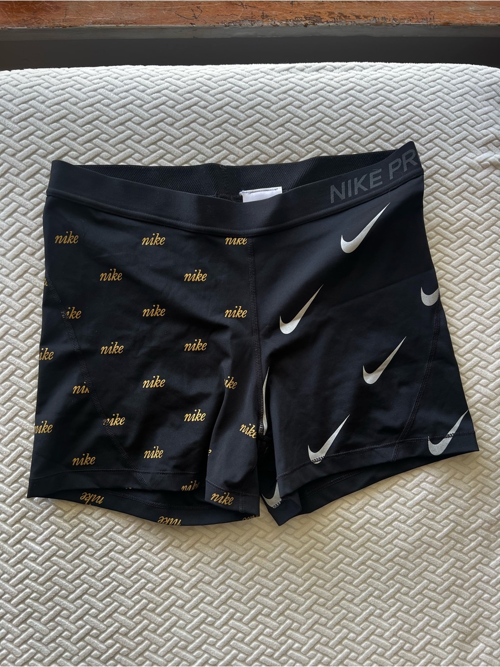 Nike Black Women's Bike Shorts with Gold Logo Print